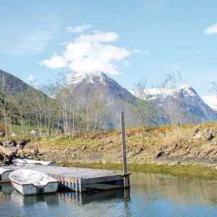 Beautiful cottages built on the fjord in Fjærland.
