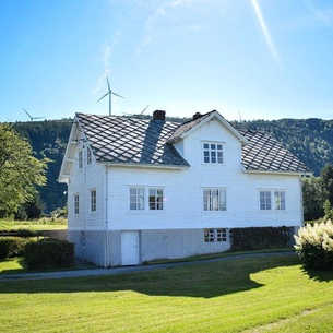 Charming cottage with view of fjord and islands.