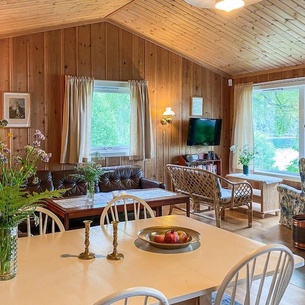 In a quiet and beautiful location by the fjord welcomes you this cozy wooden house on the water.