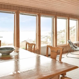 On the island of Vestre Bokn, this light-filled vacation home by the sea welcomes you.