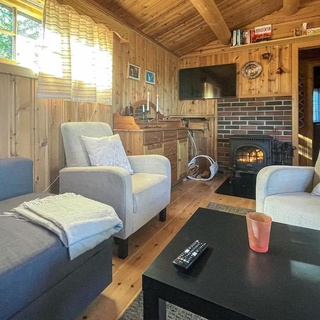 Charming cottage with fireplace and lake view.